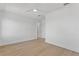 Well-lit bedroom featuring hardwood floors, white walls, and a modern ceiling fan at 6189 Leeland S St, St Petersburg, FL 33715