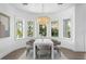 Dining room featuring a modern chandelier, with large windows and hardwood flooring at 6189 Leeland S St, St Petersburg, FL 33715