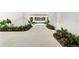 Elegant driveway featuring lush landscaping on both sides, enhancing curb appeal at 6189 Leeland S St, St Petersburg, FL 33715