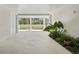 Spacious driveway with tropical plants, offering privacy and a welcoming entrance at 6189 Leeland S St, St Petersburg, FL 33715