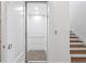 Modern home elevator with paneled walls and wood floors conveniently located next to stairs at 6189 Leeland S St, St Petersburg, FL 33715