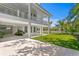 Backyard view showcases covered parking, lush lawn, and manicured tropical landscaping at 6189 Leeland S St, St Petersburg, FL 33715