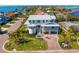 Stunning waterfront home with lush landscaping, brick driveway, and elegant architectural details at 6189 Leeland S St, St Petersburg, FL 33715
