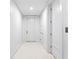Bright hallway with white walls and doors, creating a clean and modern aesthetic at 6189 Leeland S St, St Petersburg, FL 33715