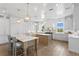 Bright kitchen features white cabinets, marble countertops, a center island, and pendant lighting at 6189 Leeland S St, St Petersburg, FL 33715