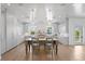 Open kitchen with wooden island and seating, stainless steel appliances, marble countertops, and bright windows at 6189 Leeland S St, St Petersburg, FL 33715
