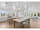 Spacious kitchen with white cabinets, marble counters, stainless appliances, island, and adjacent dining area at 6189 Leeland S St, St Petersburg, FL 33715