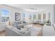 Bright living room with multiple windows, comfortable seating, and stylish decor, perfect for relaxation and entertaining at 6189 Leeland S St, St Petersburg, FL 33715