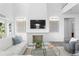 Bright living room features a fireplace with a herringbone pattern, modern lighting and hardwood floors at 6189 Leeland S St, St Petersburg, FL 33715