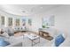 Bright living room with hardwood floors, comfortable seating, modern decor, and ample natural light creating a welcoming space at 6189 Leeland S St, St Petersburg, FL 33715