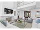 Spacious living room with fireplace, TV, hardwood floors and comfortable seating with a view of the entry at 6189 Leeland S St, St Petersburg, FL 33715