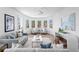 Spacious living room featuring hardwood floors, comfortable seating, and modern artwork, creating an inviting atmosphere at 6189 Leeland S St, St Petersburg, FL 33715