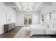 Bright main bedroom with tray ceiling, french doors to a balcony, and decorative chandelier at 6189 Leeland S St, St Petersburg, FL 33715