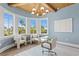 Bright and airy office space with blue walls, wood-beam ceiling, and curved window seating area at 6189 Leeland S St, St Petersburg, FL 33715