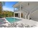 Relaxing backyard pool and patio with overhead balcony and exterior staircase at 6189 Leeland S St, St Petersburg, FL 33715