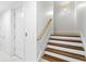 Staircase with wooden treads and white risers, complemented by a wood handrail at 6189 Leeland S St, St Petersburg, FL 33715