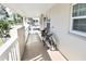 Condominium balcony with white railing and two bicycles at 930 Virginia St # 201, Dunedin, FL 34698