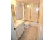Clean bathroom with a shower/tub combo, toilet and vanity with a marble top at 930 Virginia St # 201, Dunedin, FL 34698