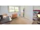 Bright bedroom with hardwood floors, featuring a dresser, chair, and large closet at 930 Virginia St # 201, Dunedin, FL 34698
