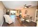 Dining room with a glass-top table and four chairs, hardwood floors and ceiling fan at 930 Virginia St # 201, Dunedin, FL 34698