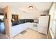 Modern kitchen with white cabinetry, granite counters, and appliances at 930 Virginia St # 201, Dunedin, FL 34698
