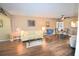 Bright living room with hardwood floors, featuring a sofa, chairs, and a dining area at 930 Virginia St # 201, Dunedin, FL 34698