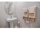 Small bathroom with pedestal sink and neutral decor at 9709 Pembrooke Pines Dr, Sun City Center, FL 33573