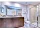 Double vanity, large mirror, and walk-in shower at 9709 Pembrooke Pines Dr, Sun City Center, FL 33573