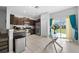 Open kitchen featuring stainless steel appliances and dark wood cabinets at 9709 Pembrooke Pines Dr, Sun City Center, FL 33573