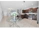 Eat-in kitchen with stainless steel appliances and a view into the living room at 9709 Pembrooke Pines Dr, Sun City Center, FL 33573