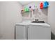 Laundry room with washer, dryer, and shelving at 9709 Pembrooke Pines Dr, Sun City Center, FL 33573