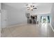 Open living room and kitchen with tile flooring and ceiling fan at 9709 Pembrooke Pines Dr, Sun City Center, FL 33573