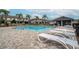 Community pool with lounge chairs and a shaded area at 9709 Pembrooke Pines Dr, Sun City Center, FL 33573