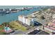 Aerial view of waterfront community, showing building, pool, tennis court, and waterway at 10216 Regal Dr # 603, Largo, FL 33774