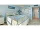 Bright bedroom with white furniture and ocean-themed decor at 10216 Regal Dr # 603, Largo, FL 33774