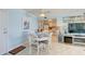 White round dining table with four chairs near kitchen and living room at 10216 Regal Dr # 603, Largo, FL 33774