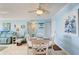 Charming dining area with white table and chairs, located near living room at 10216 Regal Dr # 603, Largo, FL 33774