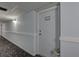 Clean hallway with light blue walls and patterned carpet leads to unit 603 at 10216 Regal Dr # 603, Largo, FL 33774