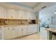 Well-equipped kitchen with white cabinets, granite countertops, and modern appliances at 10216 Regal Dr # 603, Largo, FL 33774