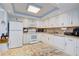 Updated kitchen featuring white cabinets, granite counters, and stainless steel appliances at 10216 Regal Dr # 603, Largo, FL 33774