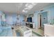 Open living space with light blue walls, comfy furniture, and views at 10216 Regal Dr # 603, Largo, FL 33774