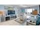 Bright living room with light blue walls, comfy furniture, and balcony access at 10216 Regal Dr # 603, Largo, FL 33774