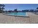 Relaxing community pool with surrounding patio at 10216 Regal Dr # 603, Largo, FL 33774