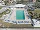 Community pool with plenty of lounge chairs and umbrellas at 10216 Regal Dr # 603, Largo, FL 33774