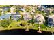 Aerial view of lakefront homes with private docks and lush landscaping at 10511 Martinique Isle Dr, Tampa, FL 33647