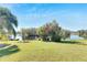 Spacious backyard with lake view, lush landscaping, and a relaxing atmosphere at 10511 Martinique Isle Dr, Tampa, FL 33647