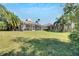 Large backyard with screened enclosure and canal view at 10511 Martinique Isle Dr, Tampa, FL 33647