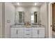 Double vanity bathroom with granite countertops and large mirrors at 10511 Martinique Isle Dr, Tampa, FL 33647