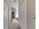 Long hallway with double doors leading to the bathroom at 10511 Martinique Isle Dr, Tampa, FL 33647