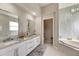 Modern bathroom with double vanity and a soaking tub at 10511 Martinique Isle Dr, Tampa, FL 33647